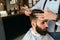 Men Haircut. Barber Cutting Man`s Hair In Barber Shop