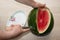 Men hand hold from on fresh watermelon cutting for eatin on table background