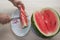 Men hand hold from on fresh watermelon cutting for eatin on table background