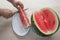 Men hand hold from on fresh watermelon cutting for eatin on table background