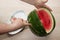 Men hand hold from on fresh watermelon cutting for eatin on table background