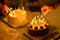 Men hand lights candles on birthday cake