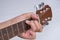 Men hand play the guitar gray background. Select focus.