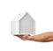 Men hands hold little house model isolated on white background. Property real estate Investment concept