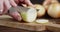 Men hands slicing onion on cutting Board.