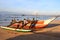 Men hauling a traditional fishing boat ashore