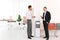 Men having break near water cooler at workplace.