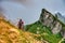 Men hikes to mountain top cross in the swiss nature and mountain region of Speer, Federispitz, Chuemettler, Grappehorn