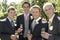 Men Holding Champagne Flutes At Wedding