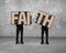 Men holding two cracked FAITH word wooden boards.