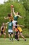 Men Jump For Ball In Amateur Australian Rules Football Game