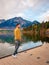 Men by the lake watching sunset, Pyramid lake Jasper during autumn in Alberta Canada, fall colors by the lake during