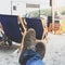 Men legs in sneakers on background of deckchairs on beach