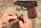 Men load ammo in the clip Makarov pistol