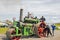 Men looking at a steam engine at a steam rally