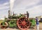 Men looking at a steam engine at a steam rally