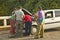 Men looking under the hood and repairing broken down Fiat car in the Valle de Viï¿½ales, in central Cuba