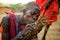 Men Masai tribe make a fire in the traditional way.