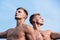 Men muscular chest naked torso sky background. Men muscular athlete bodybuilder relaxing lean each other. Masculinity