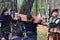 men in national Scottish costumes show a historical scene