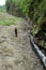 Men observing land structure with small river trough it