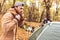 Men pitching tent in autumn forest