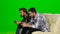 Men play on the console in the same team. Green screen