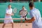 Men playing doubles game tennis