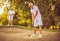 Men playing golf. Focus is on foreground