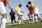 Men Playing Soccer While Referee Watching Them