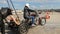 Men Push Motorcycle Helping Biker to Start Motor on Square