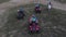 Men on quad bikes and racing motorcycle ride on desert