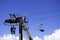 Men repairing a cable chair up on the pylon, high in the sky