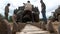 Men reparing caterpillar of the world war two American Sherman tank