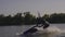 Men ride a jetski on a river