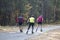 Men ride roller skis in the autumn Park