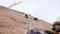 Men rock climbing a steep vertical granite rock climbing route in the French Alps near Mont Blanc above white snow glacier