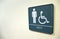 Men's bathroom sign on white wall with handicapped symbol