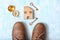 Men`s brown boots, compass, keys and a house on a light background