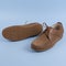Men`s brown moccasins, loafers isolated on blue background. Side view, top