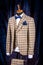 Men`s business suit on mannequin, vintage color. elegant sand-colored three-piece suit in a cage with a bow tie and a