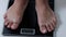 men\'s feet stand on the scales weight control