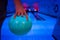 Men`s hand holding a blue bowling ball ready to throw