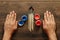 Men`s hands, brushes and open paint on a brown wooden table. Close-up, top view. The concept of creativity, creativity