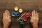 Men`s hands, brushes and open paint on a brown wooden table. Close-up, top view. The concept of creativity, creativity