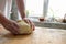 Men`s hands crumple the dough. Preparation of dough for dumplings