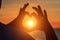 Men`s hands in the form of heart against sunlight in sunset sky, twilight time. Hands in shape of love heart, Love concept