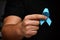 Men`s hands hold a blue ribbon. November month health check. Prevention of prostatitis. Cancer Awareness. No Shave Month.