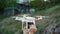 Men`s hands hold drone and drone soars into the sky