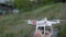 Men`s hands hold drone. operator calibrates quadrocopter before flight